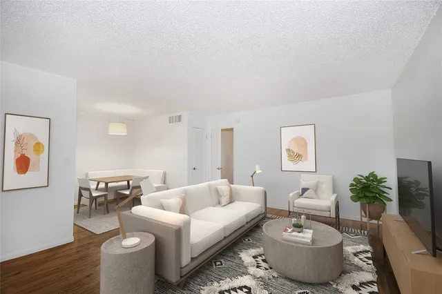 a living room with furniture and wooden floor