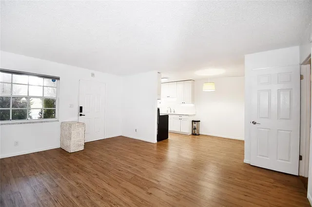 a view of a kitchen with wooden floor