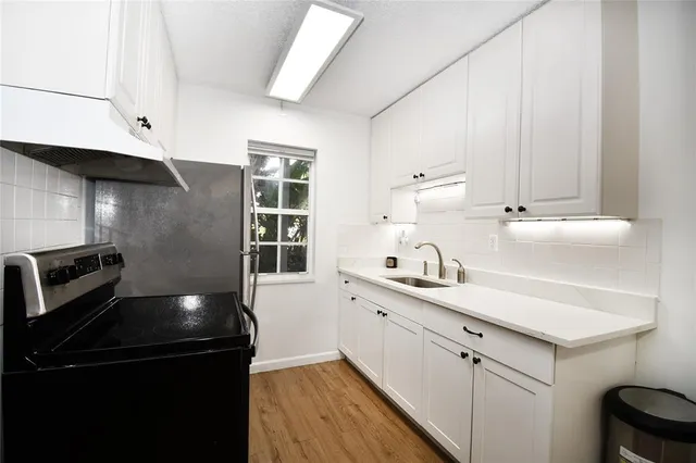 a kitchen with a sink and cabinets