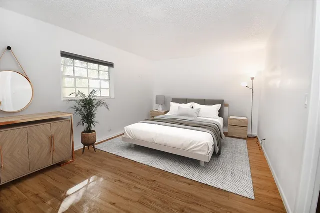 a bedroom with a bed a mirror and a window