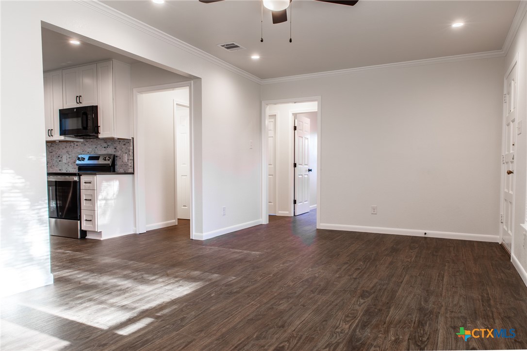 2019 South 9th Street Temple, TX 76504 - Photo 6 of 23 Spacious living room with lots of natural light. Open to kitchen with hallway leading to the bedrooms.