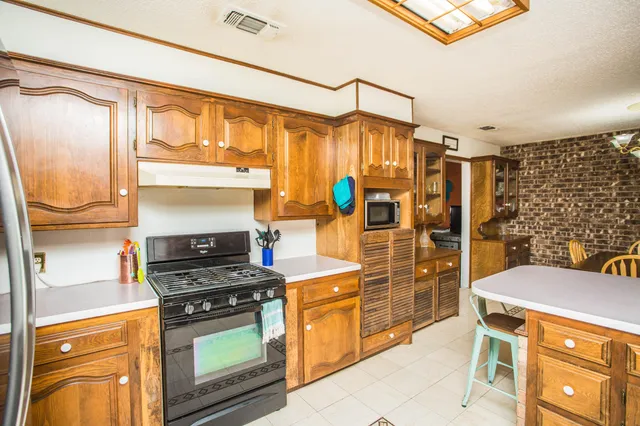 a kitchen with stainless steel appliances a stove and a refrigerator