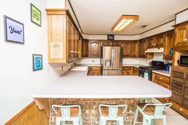a view of kitchen with furniture and wooden floor