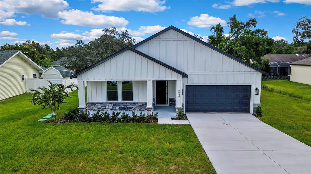 6589 Freeport Drive Spring Hill, FL 34608 - Photo 2 of 63 a front view of house with a garden