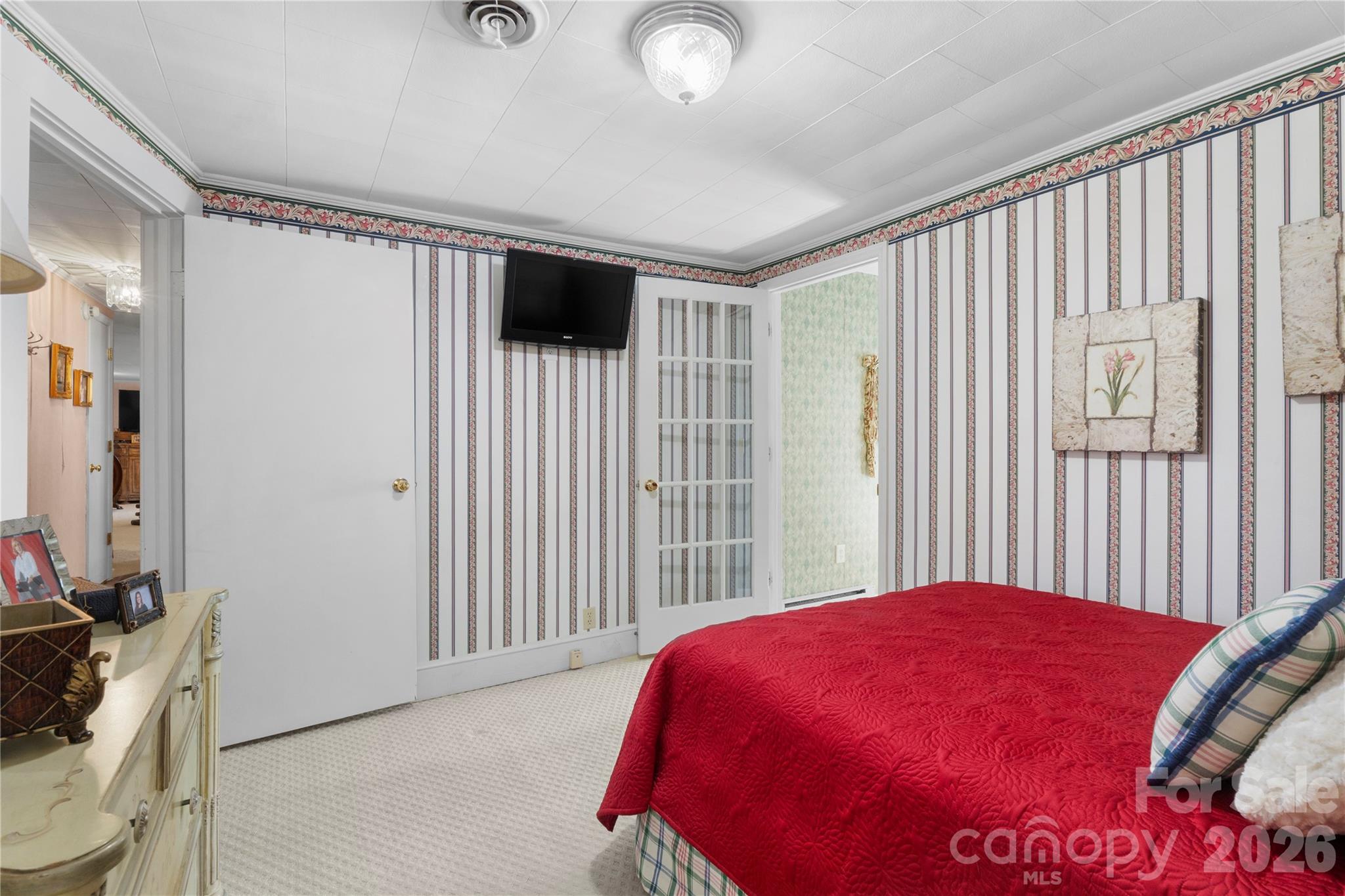 1687 Sexton Road, Unit 5 Denton, NC 27239 - Photo 20 of 48 a bedroom with a large bed and a flat tv screen