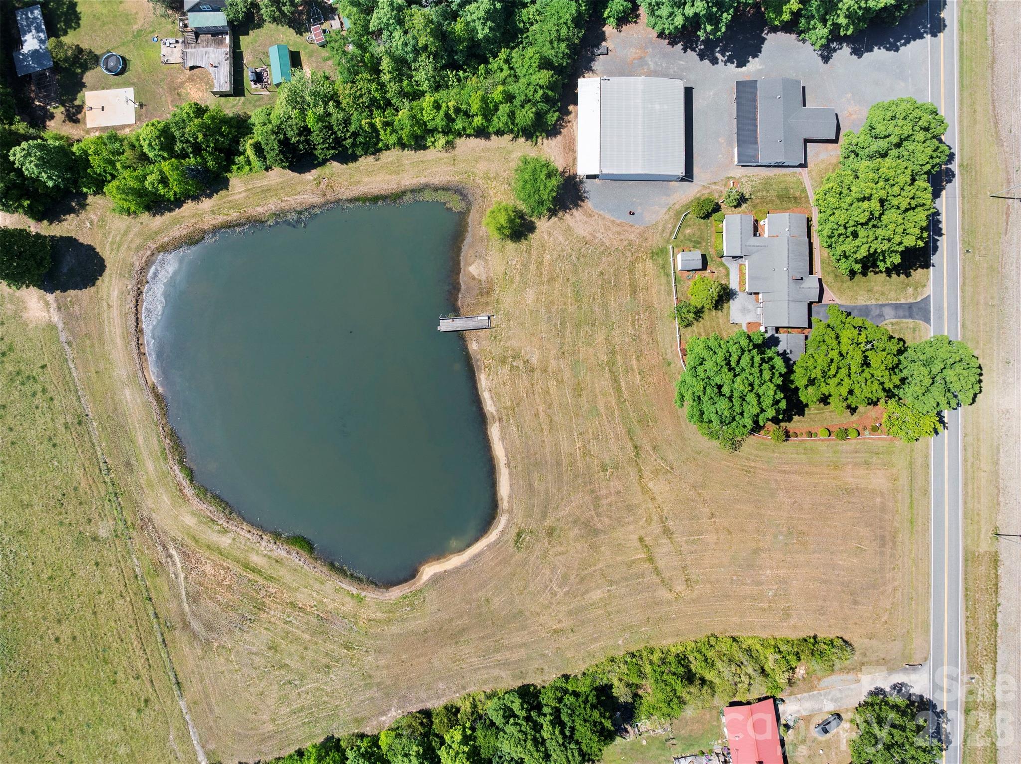 1687 Sexton Road, Unit 5 Denton, NC 27239 - Photo 47 of 48 an aerial view of a house with a yard and large trees