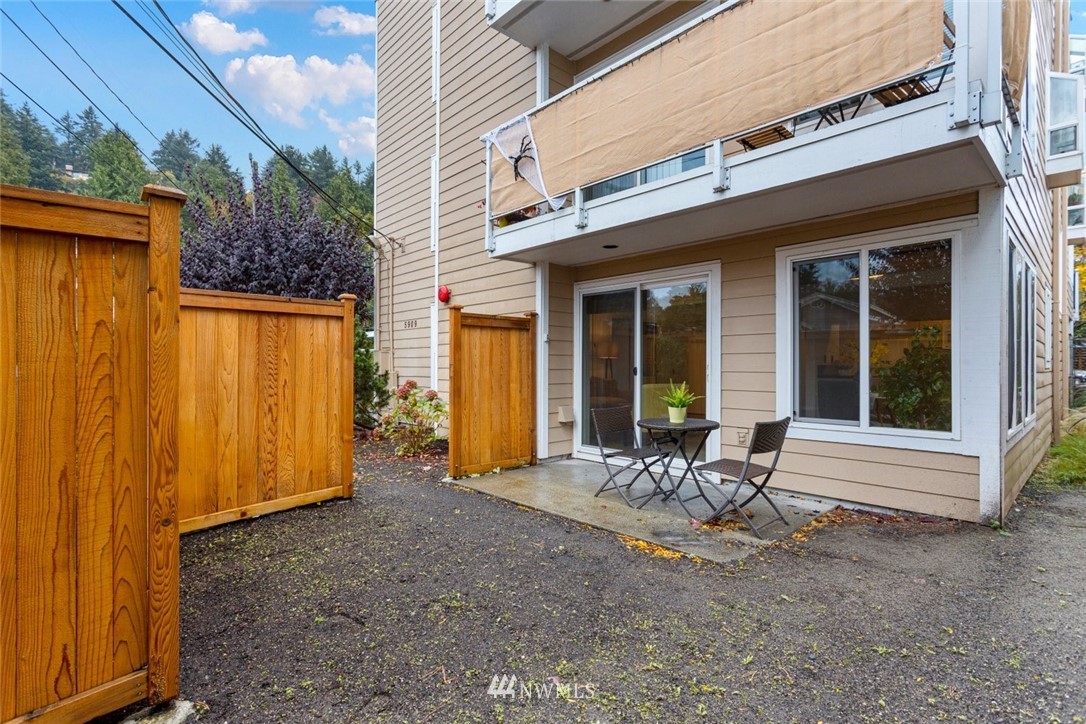 5909 Southwest Carroll Street, Unit 101 Seattle, WA 98116 - Photo 1 of 12 a view of a chair and table in front of house