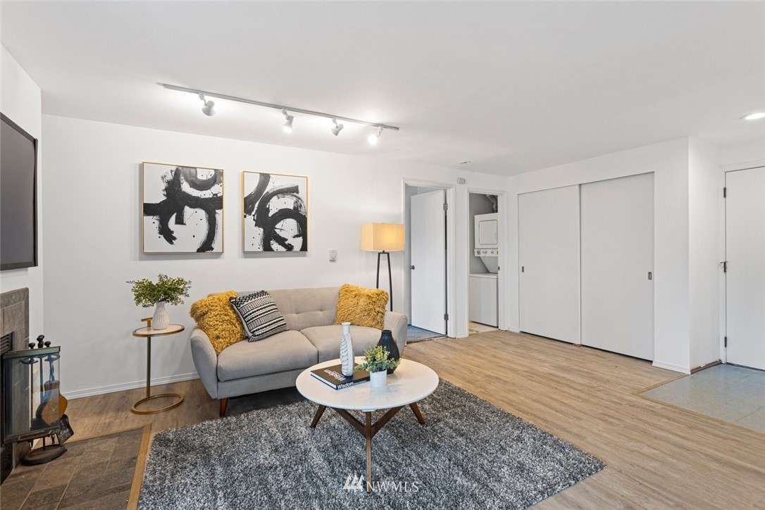 5909 Southwest Carroll Street, Unit 101 Seattle, WA 98116 - Photo 3 of 12 a living room with furniture and a wooden floor