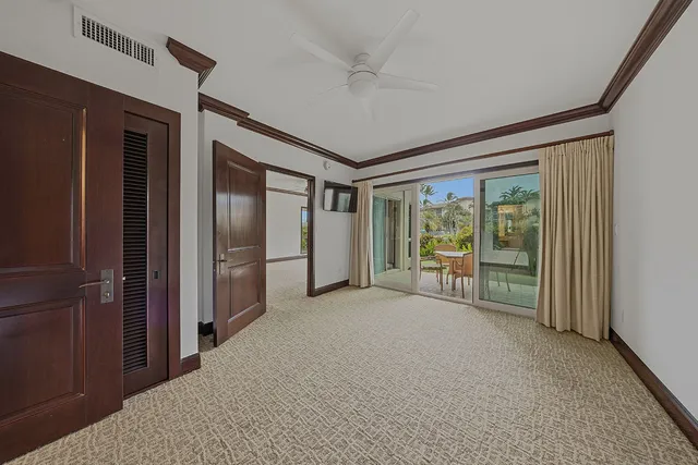 a bedroom with a bed and large windows