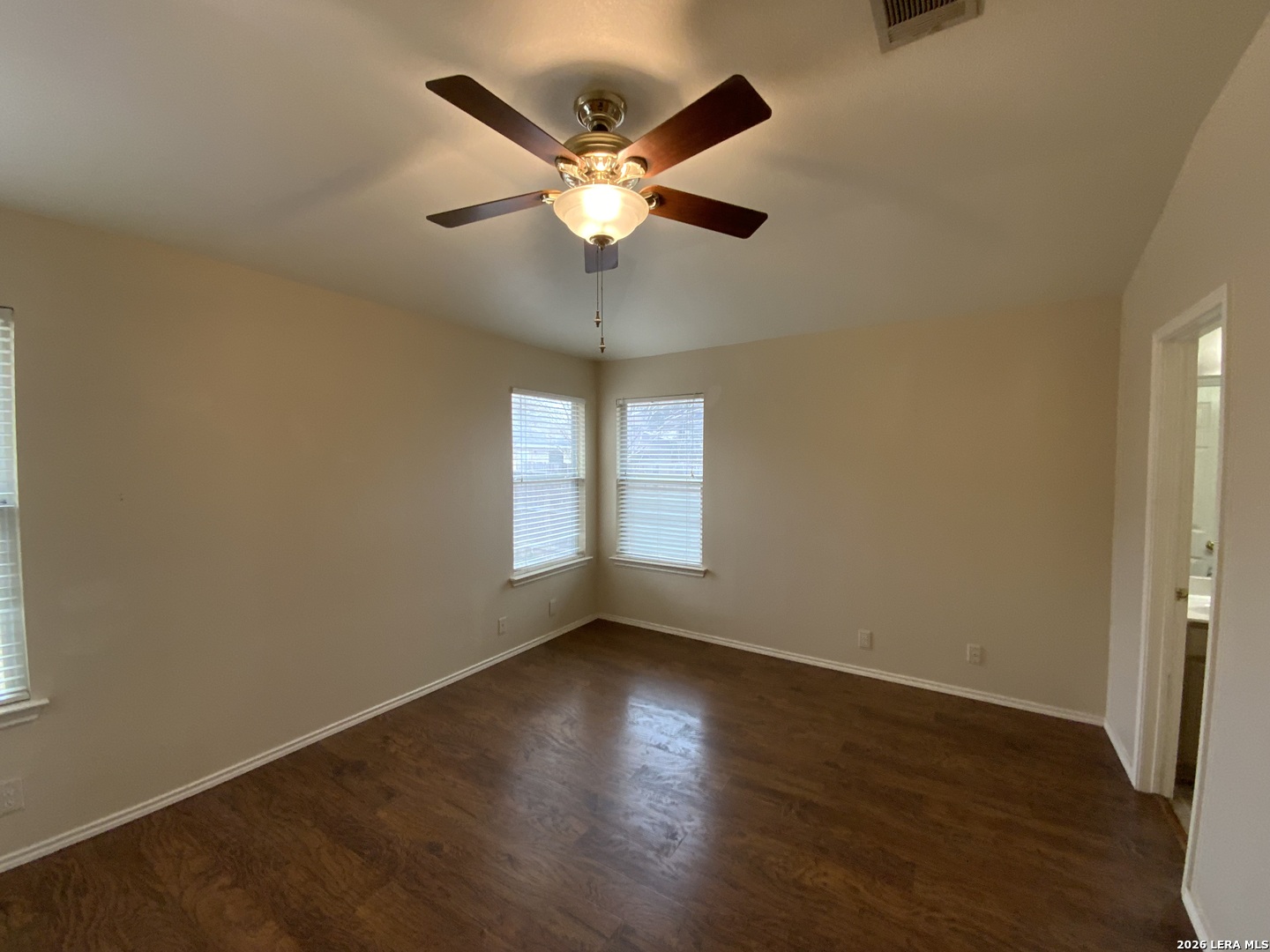 9030 Pinseeker Selma, TX 78154 - Photo 11 of 16 a view of an empty room with wooden floor and a window