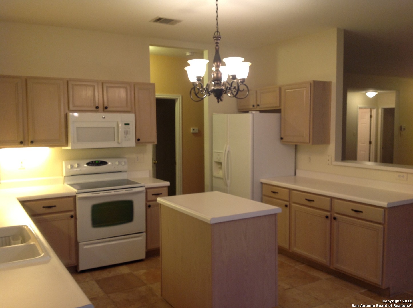 9030 Pinseeker Selma, TX 78154 - Photo 8 of 16 a kitchen with a stove sink and refrigerator