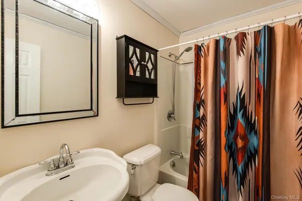 a bathroom with a sink a toilet and shower curtain
