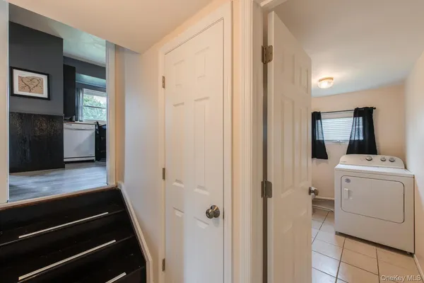 a view of a hallway with washer and dryer