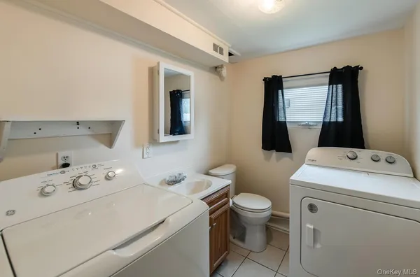 a view of bathroom with a washer and dryer