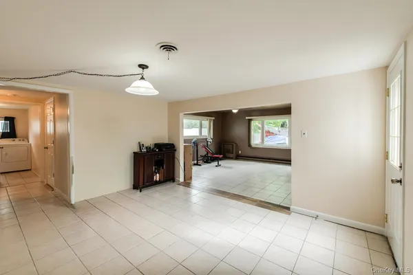 an empty room with windows and fireplace