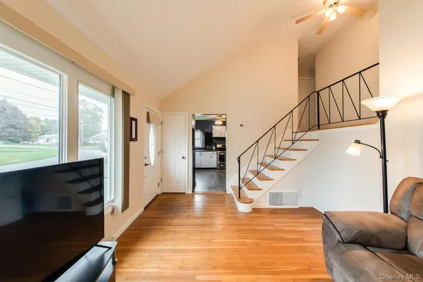 a view of entryway and hall with wooden floor