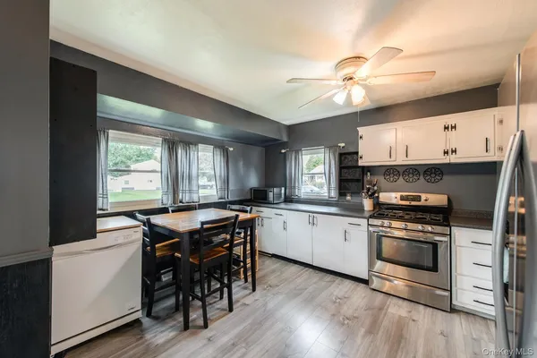 a kitchen with a stove a sink and a refrigerator