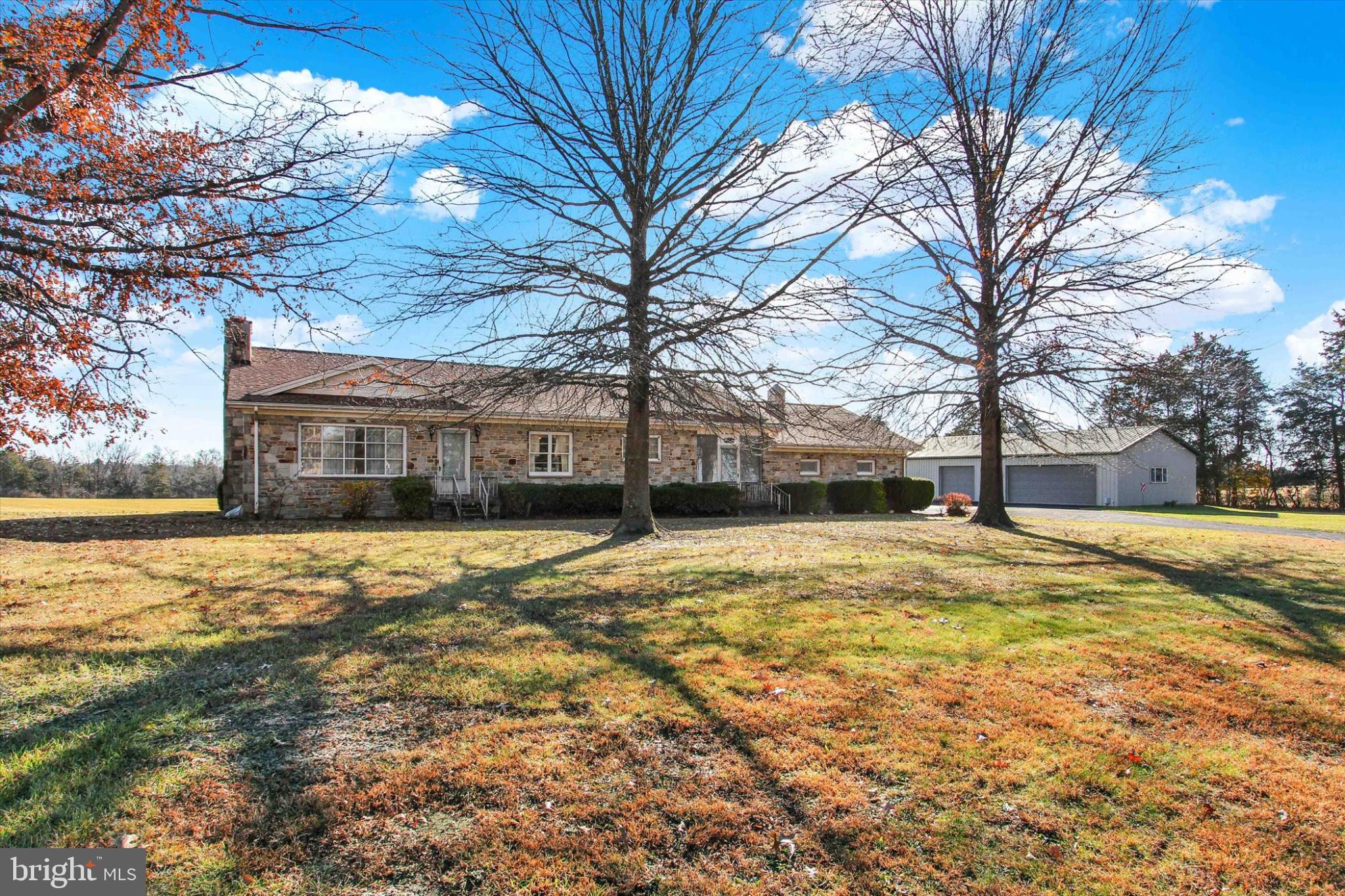 a yellow house with trees in front of it