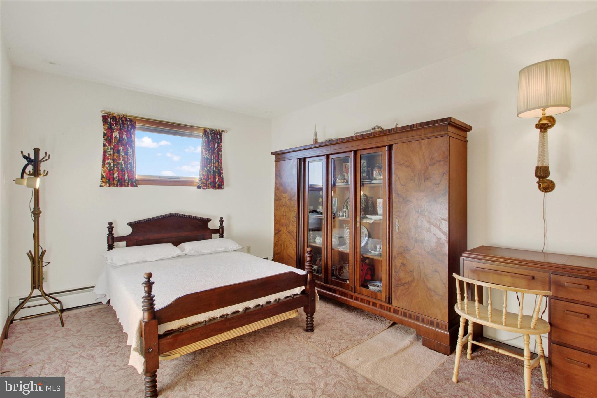 930 Hoffman Road Gettysburg, PA 17325 - Photo 16 of 36 a bedroom with a bed and large windows
