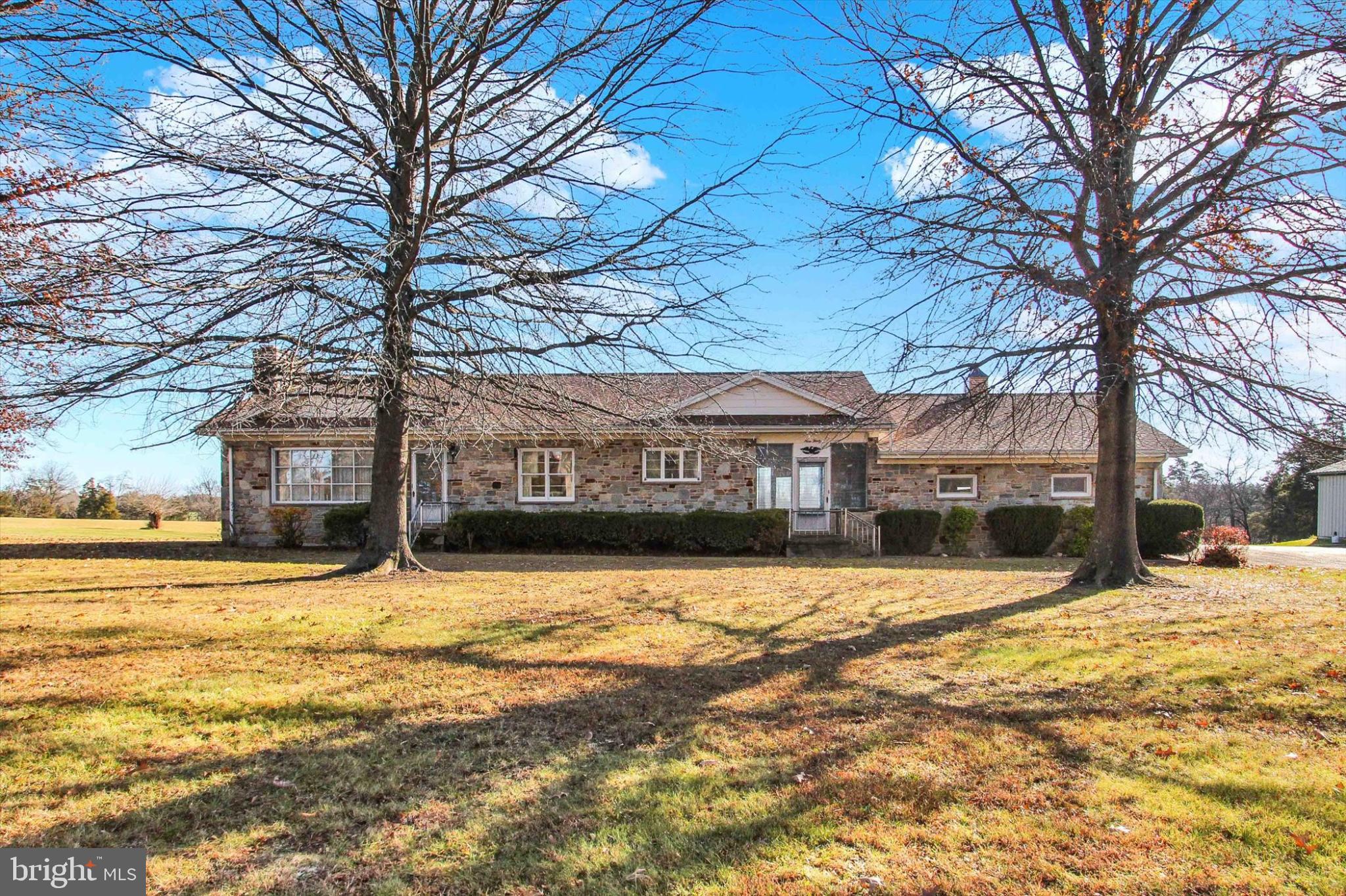 930 Hoffman Road Gettysburg, PA 17325 - Photo 34 of 36 a view of a large building next to a road with large trees