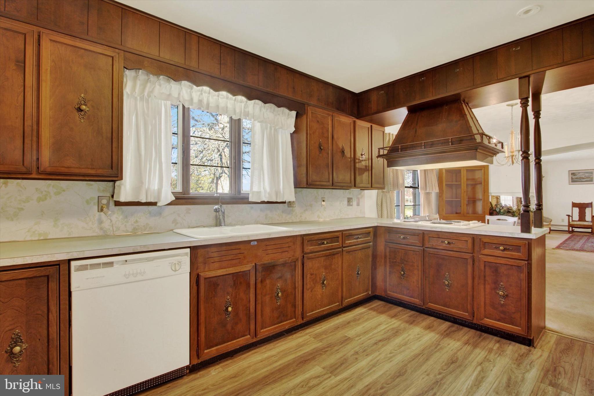 930 Hoffman Road Gettysburg, PA 17325 - Photo 9 of 36 a kitchen with granite countertop wooden cabinets a sink and a window