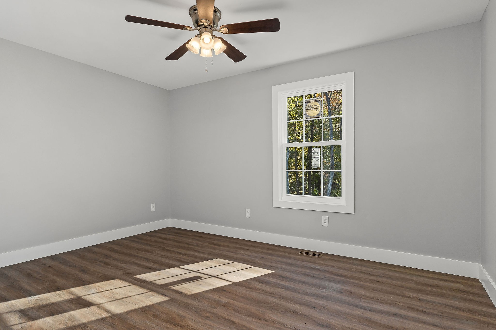 1053 Benton Tidwell Road Hilham, TN 38568 - Photo 11 of 27 a view of an empty room with wooden floor and a window