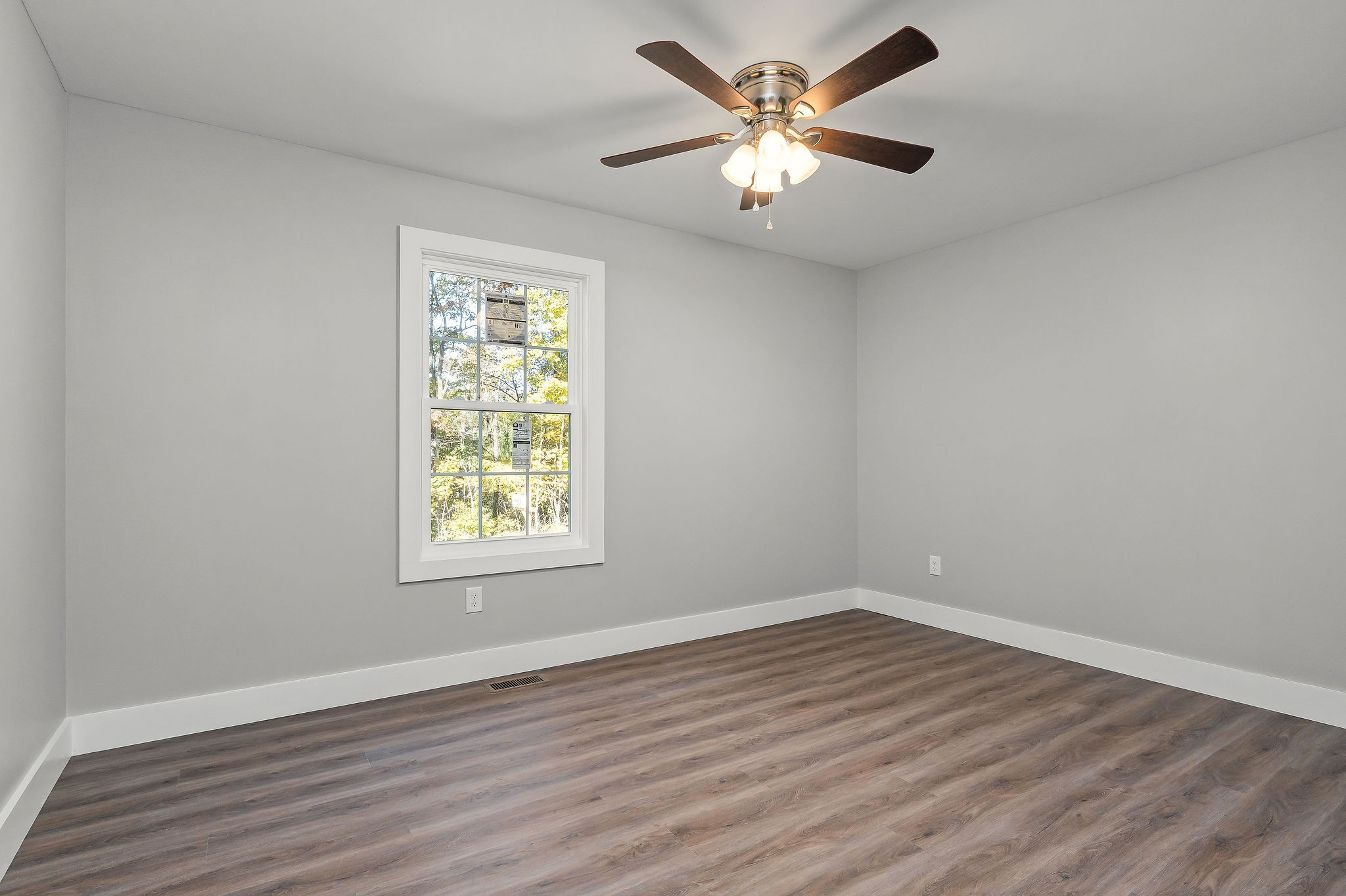 1053 Benton Tidwell Road Hilham, TN 38568 - Photo 14 of 27 a view of an empty room with wooden floor and a window