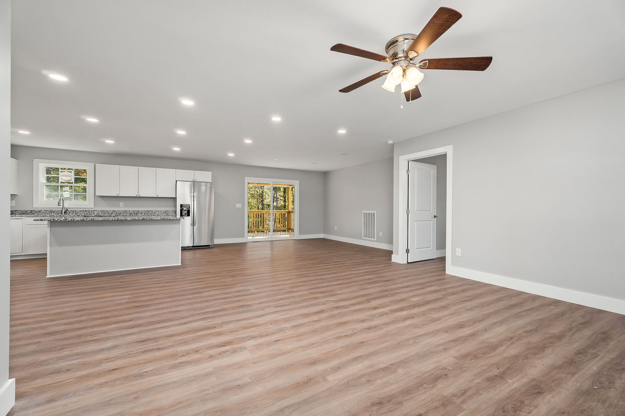 1053 Benton Tidwell Road Hilham, TN 38568 - Photo 2 of 27 a view of an empty room with window wooden floor and a kitchen