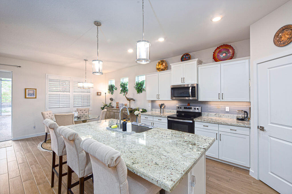 4480 Northwest Oakleaf Court Jensen Beach, FL 34957 - Photo 17 of 63 a kitchen with granite countertop lots of counter top space