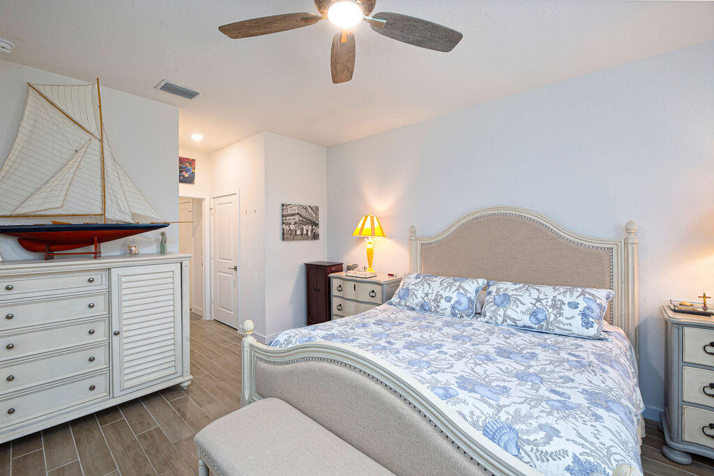 4480 Northwest Oakleaf Court Jensen Beach, FL 34957 - Photo 21 of 63 a bedroom with a bed and a television