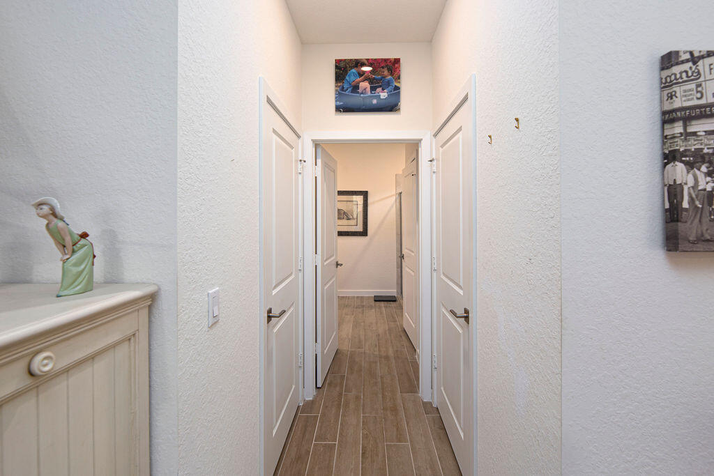 4480 Northwest Oakleaf Court Jensen Beach, FL 34957 - Photo 22 of 63 a view of a hallway with wooden floor