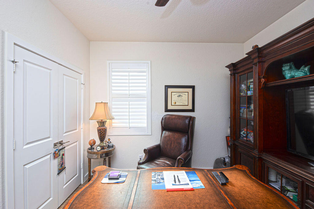 4480 Northwest Oakleaf Court Jensen Beach, FL 34957 - Photo 28 of 63 a room with furniture and a flat screen tv