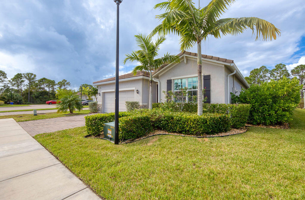 4480 Northwest Oakleaf Court Jensen Beach, FL 34957 - Photo 3 of 63 a front view of a house with porch