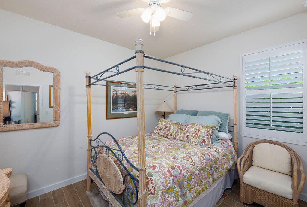 4480 Northwest Oakleaf Court Jensen Beach, FL 34957 - Photo 31 of 63 a bedroom with a bed chair and the window