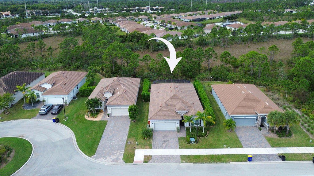 4480 Northwest Oakleaf Court Jensen Beach, FL 34957 - Photo 43 of 63 an aerial view of multiple houses with yard