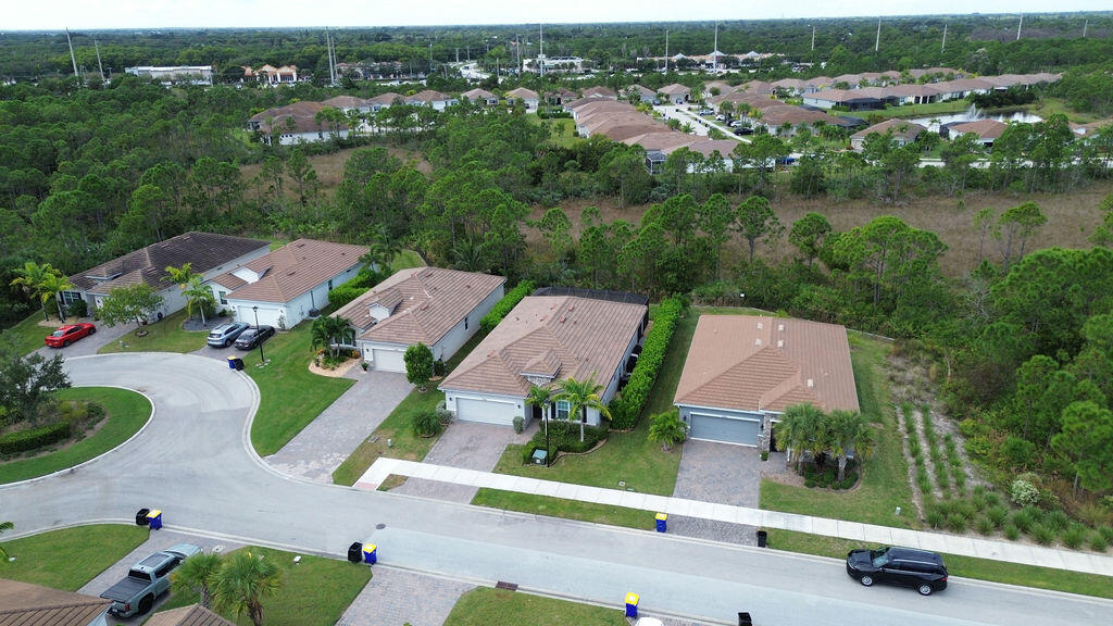 4480 Northwest Oakleaf Court Jensen Beach, FL 34957 - Photo 44 of 63 an aerial view of multiple houses with yard