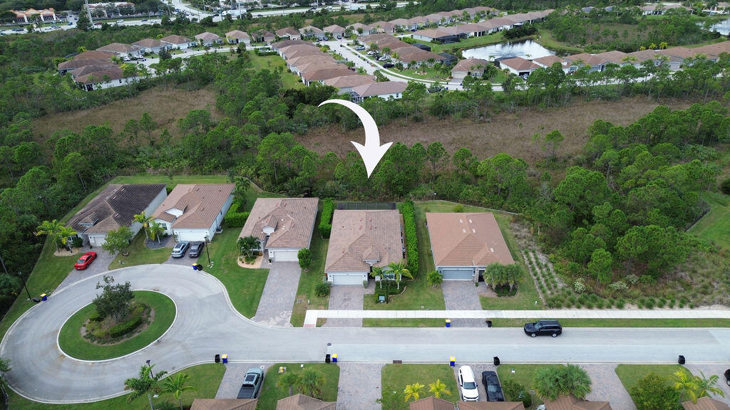 4480 Northwest Oakleaf Court Jensen Beach, FL 34957 - Photo 45 of 63 an aerial view of residential houses with outdoor space and lake view
