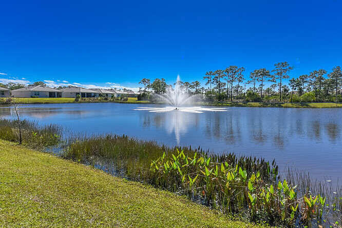 4480 Northwest Oakleaf Court Jensen Beach, FL 34957 - Photo 52 of 63 a view of a lake with a building in the background