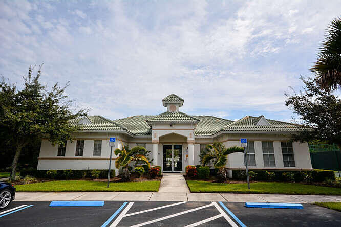 4480 Northwest Oakleaf Court Jensen Beach, FL 34957 - Photo 55 of 63 a front view of a house with a garden