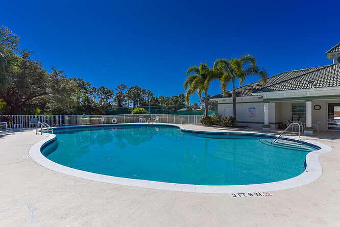 4480 Northwest Oakleaf Court Jensen Beach, FL 34957 - Photo 57 of 63 a view of a swimming pool with a yard