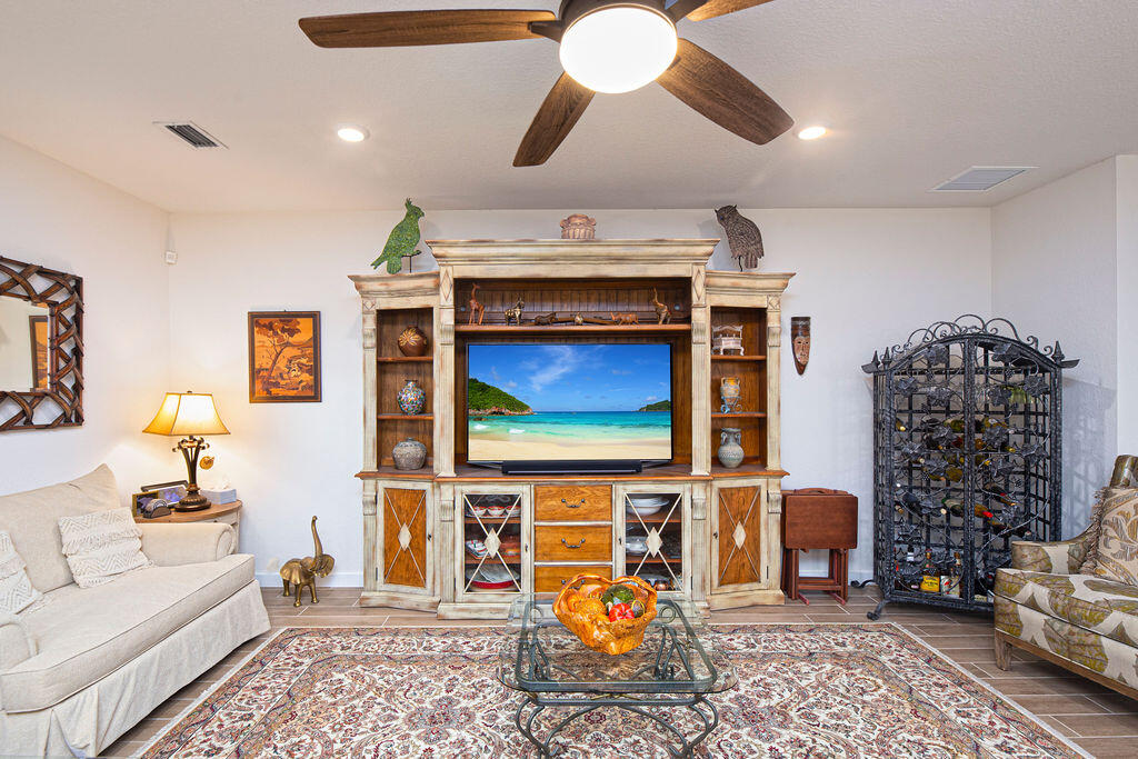 4480 Northwest Oakleaf Court Jensen Beach, FL 34957 - Photo 9 of 63 a living room with furniture a flat screen tv and rug