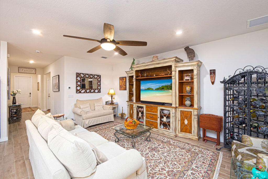 4480 Northwest Oakleaf Court Jensen Beach, FL 34957 - Photo 10 of 63 a living room with furniture and a flat screen tv
