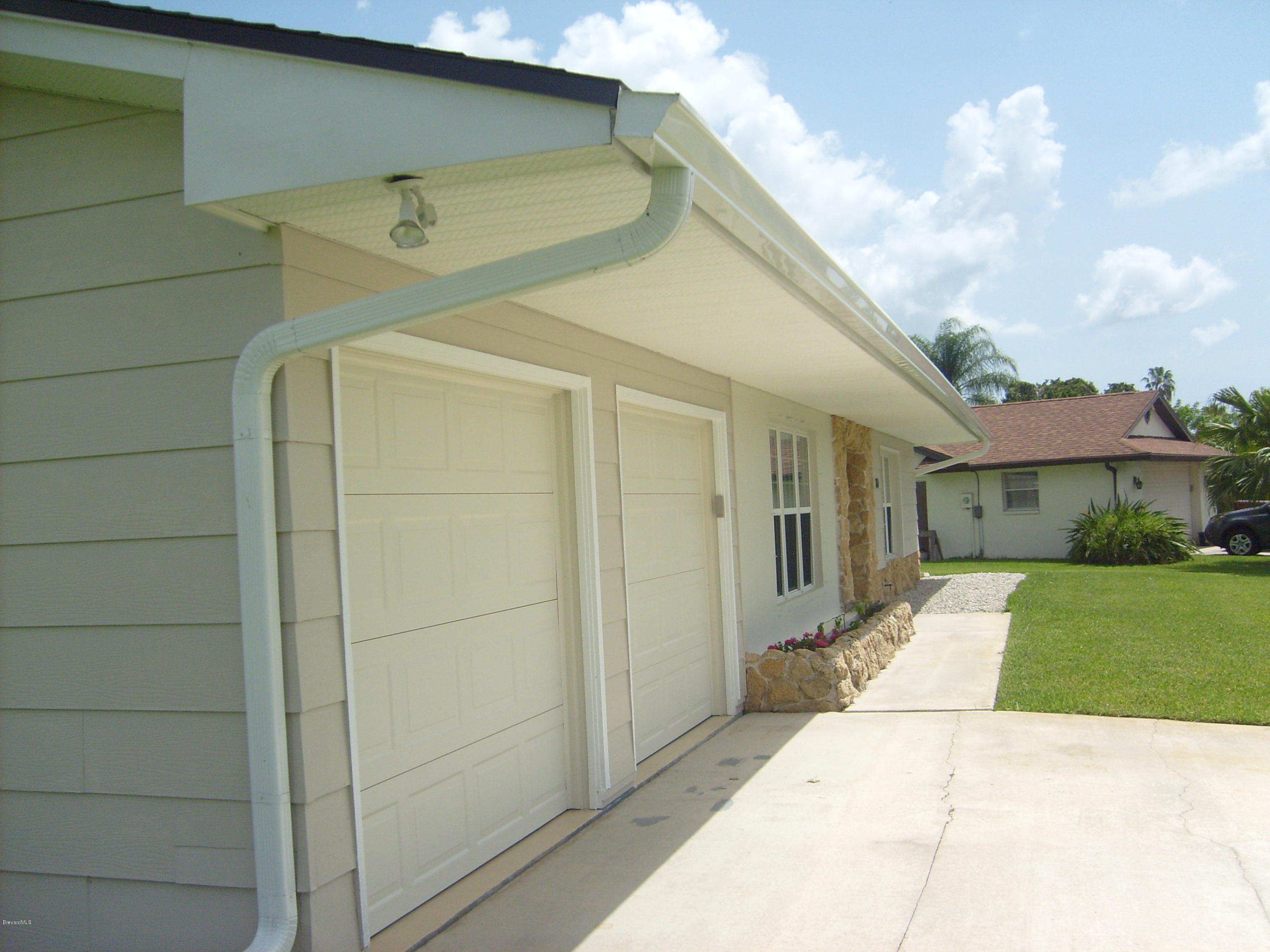 760 Montclair Road Northeast Palm Bay, FL 32905 - Photo 5 of 70 Left front seamless gutters and walkway