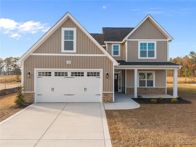 a view of a house with a yard and garage