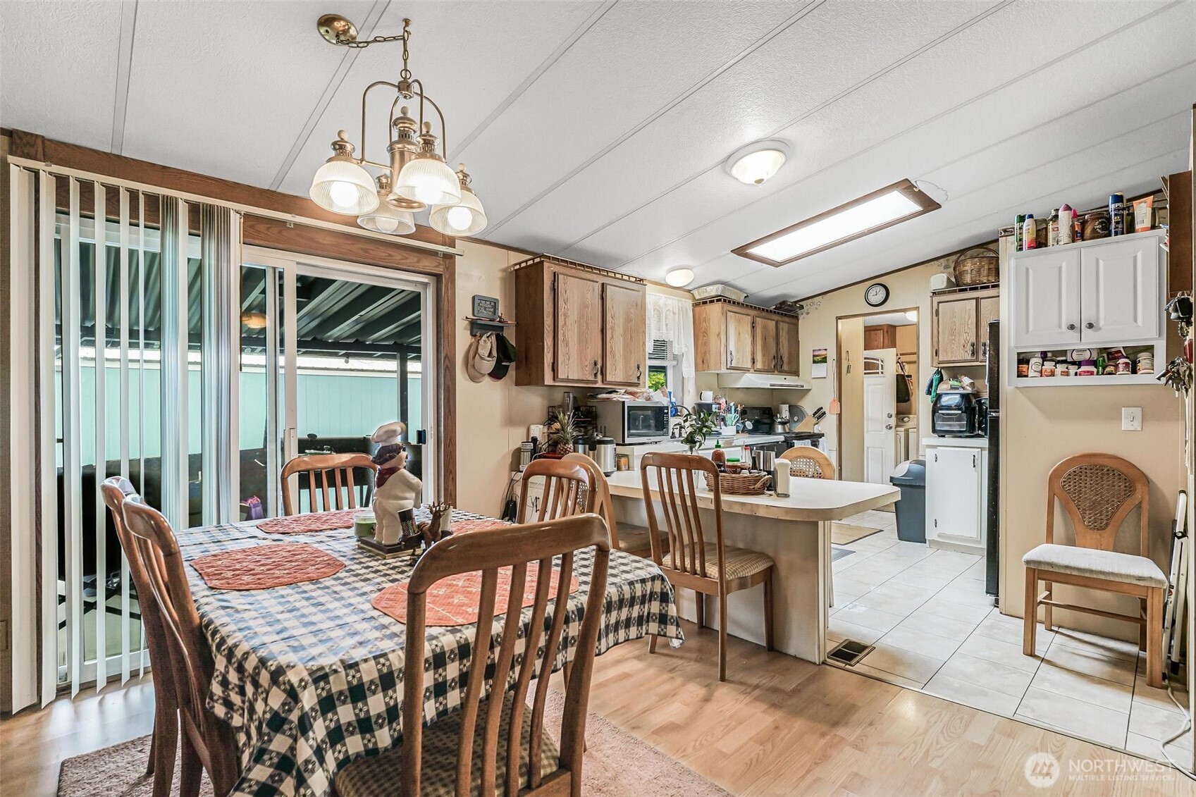 980 South Falcon Road Camano Island, WA 98282 - Photo 7 of 30 a dining room with furniture a chandelier and window
