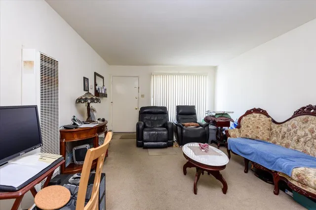 a living room with furniture and a chair