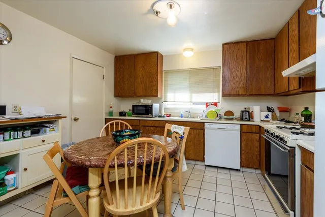 a kitchen with a stove a sink and a cabinets