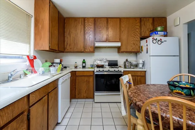 a kitchen with stainless steel appliances granite countertop a refrigerator sink and cabinets