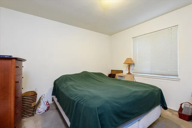 a bedroom with a bed and chair