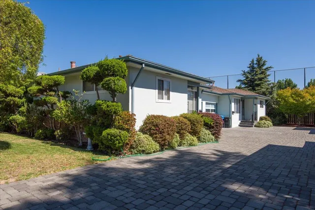 a front view of a house with garden